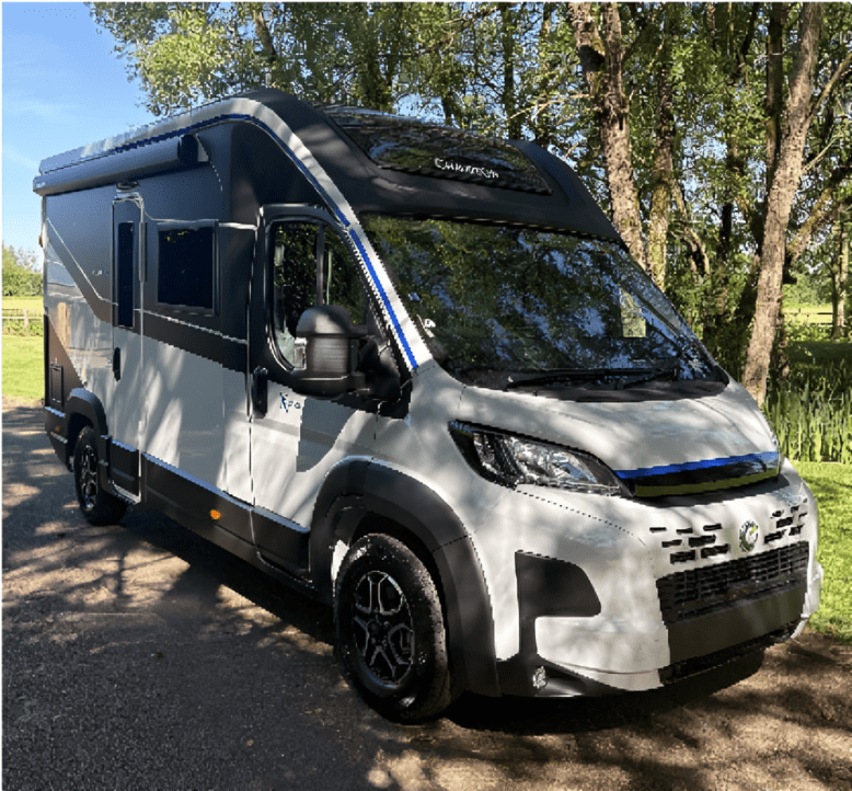 White campervan parked on shaded country road