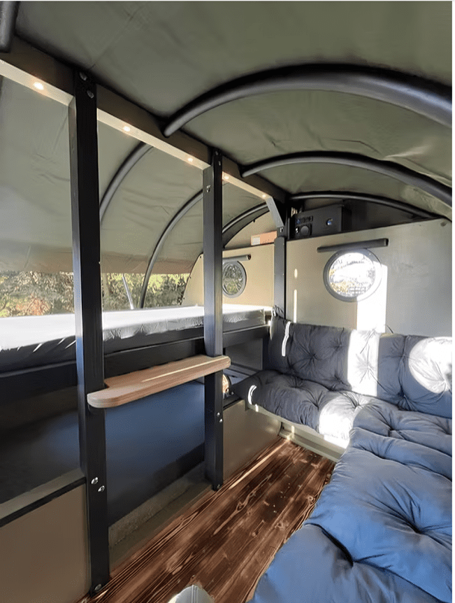 Cozy camper interior with bunk bed and sofa