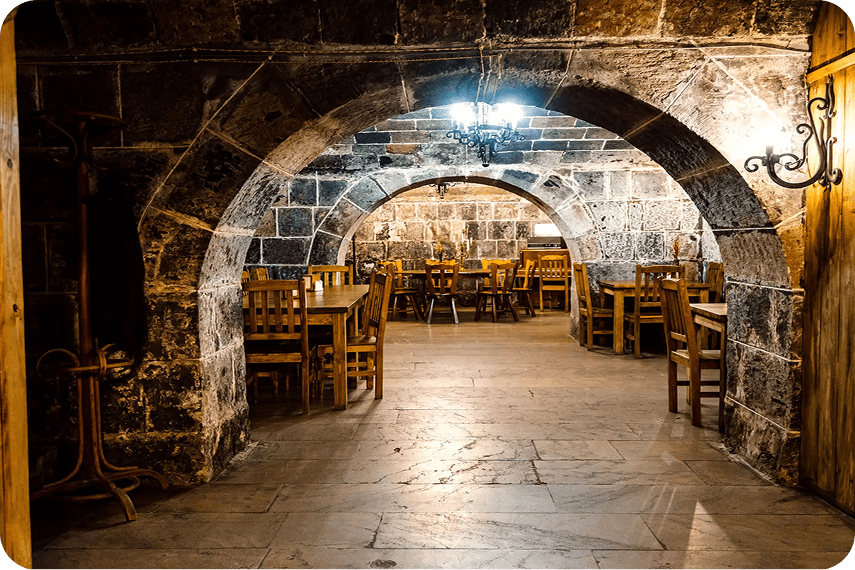 Historic dining room with wooden chairs.